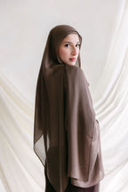 Deep taupe fabric swatch from Threads by Farah, shown in a professional branding photoshoot setting.