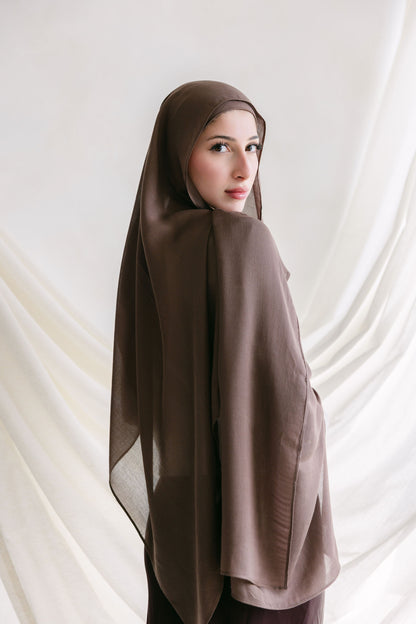 Deep taupe fabric swatch from Threads by Farah, shown in a professional branding photoshoot setting.