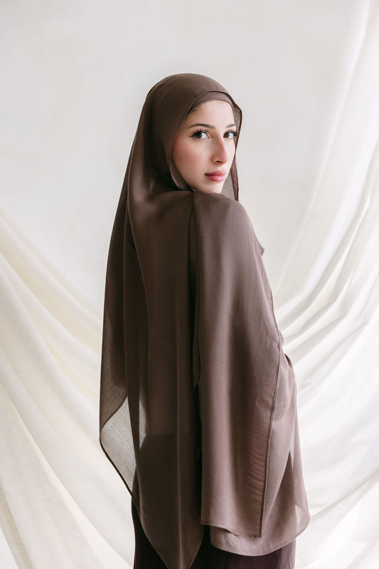 Deep taupe fabric swatch from Threads by Farah, shown in a professional branding photoshoot setting.