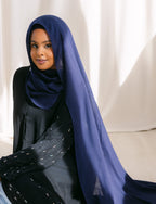 Navy blue clothing from Threads by Farah, displayed in a professional photoshoot with natural lighting and stylish setting.