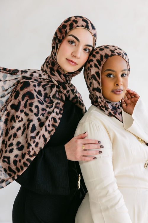 Close-up of a cheetah with spotted fur, showcasing natural patterns on a Threads by Farah product.